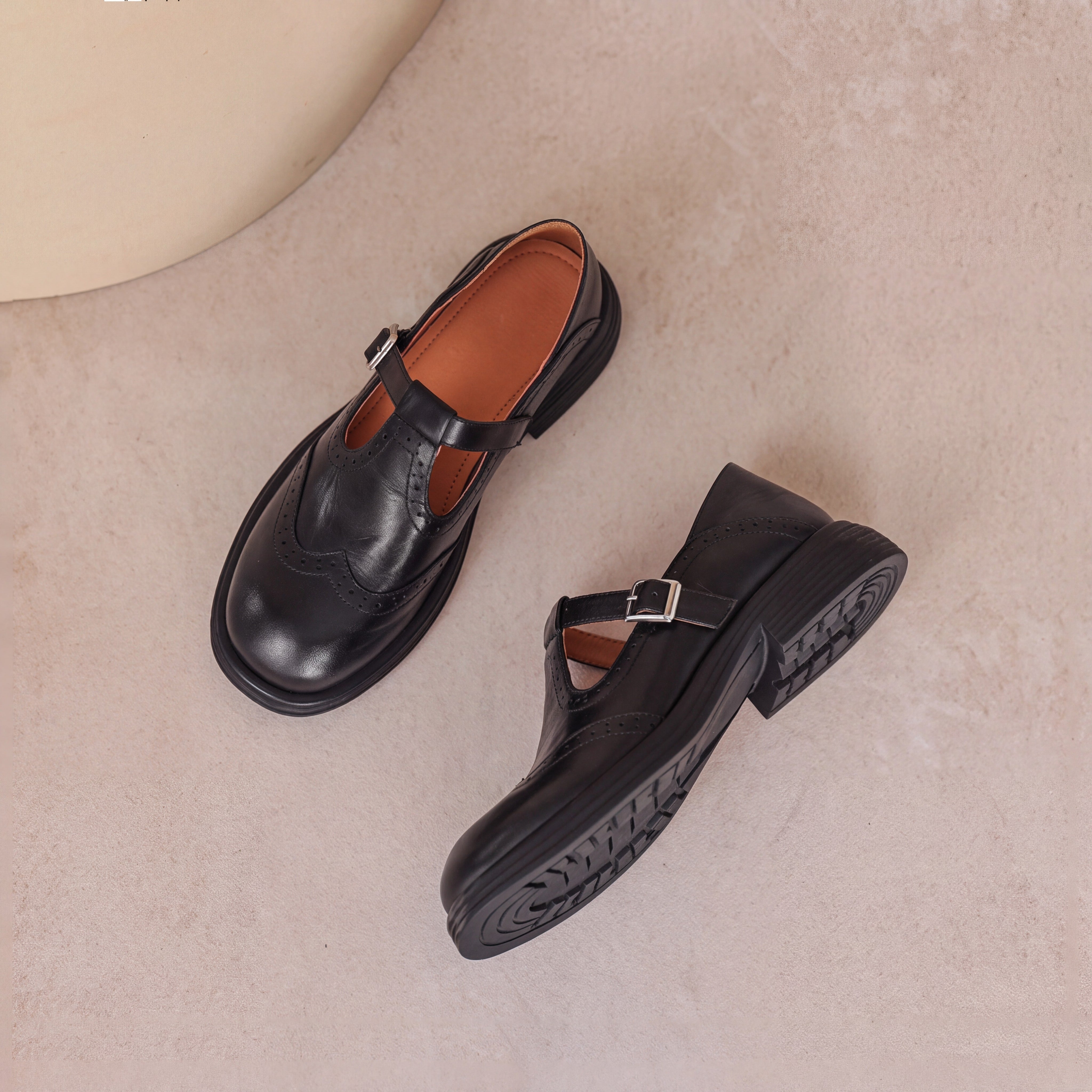 Perforated Wingtip Leather Mary Janes Black, photo studio